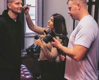 People preparing for a photoshoot indoors.